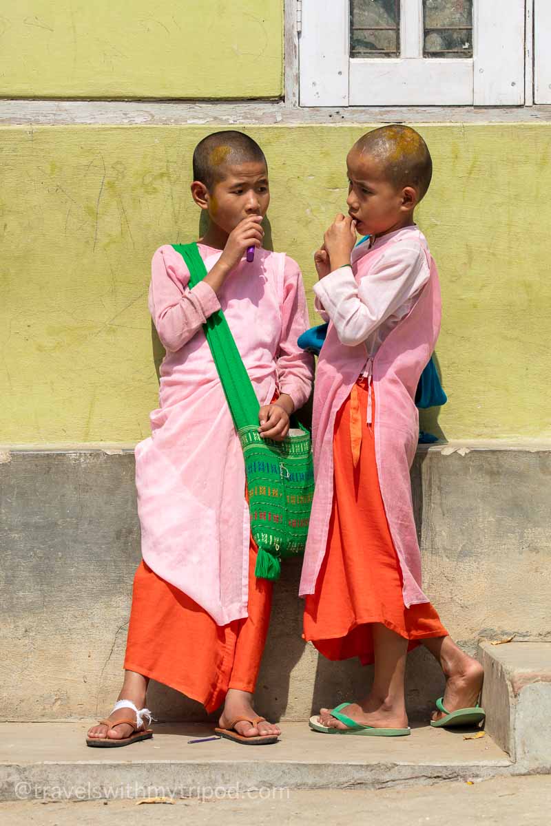 Two young students at the Aung Myae Oo Monastic Free Education School in Myanmar enjoy a snack