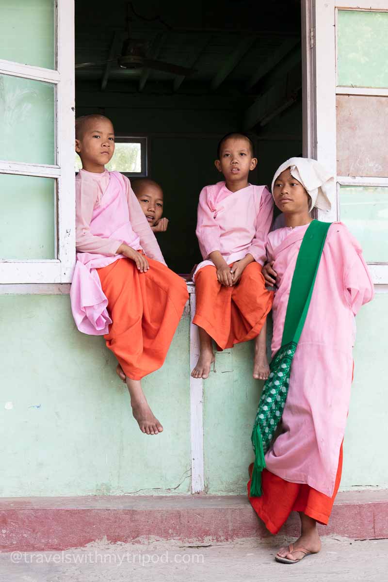 Young students stand by a window at the Aung Myae Oo Monastic Free Education School in Myanmar