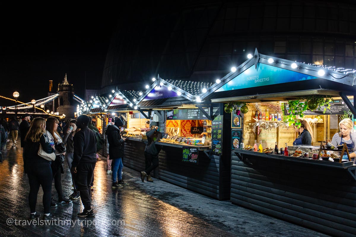 Do some last-minute shopping at a Christmas market on Christmas Eve