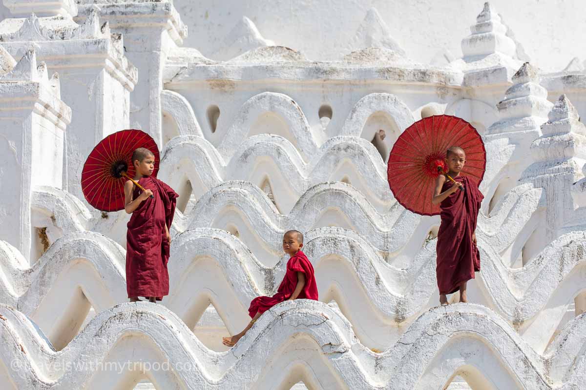 3 young monks on the curves of Hsinbyume Pagoda in Mingun