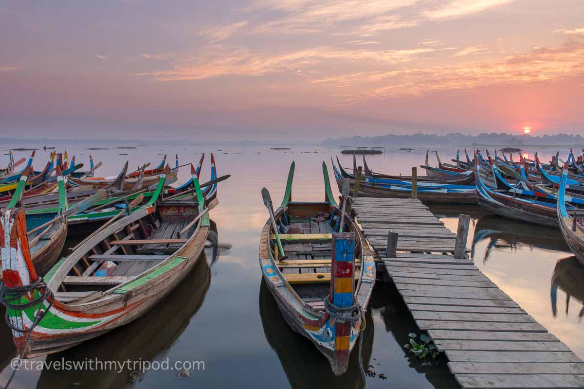 Rowing boats on Taungthaman Lake in Myanmar at sunrise